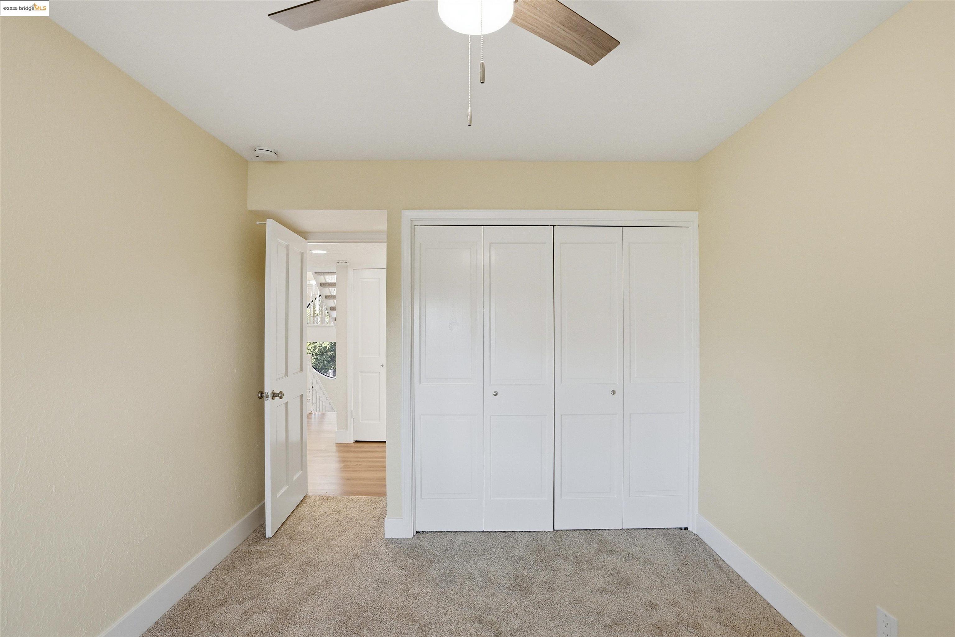2796 Taylor Road Bethel Island, CA 94511 - Photo 22 of 49 Unfurnished bedroom featuring a closet, light colored carpet, and a ceiling fan