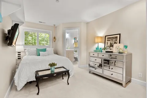 a spacious bedroom with a bed and a large window