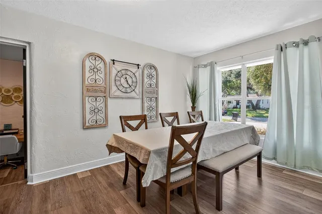 a view of a dining room with furniture window and wooden floor