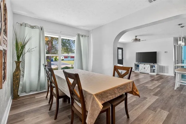a view of a dining room with furniture window and wooden floor