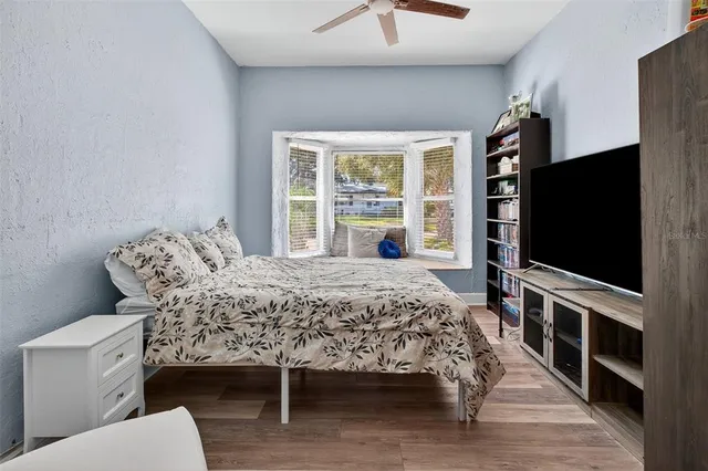 a bedroom with a bed and a flat screen tv