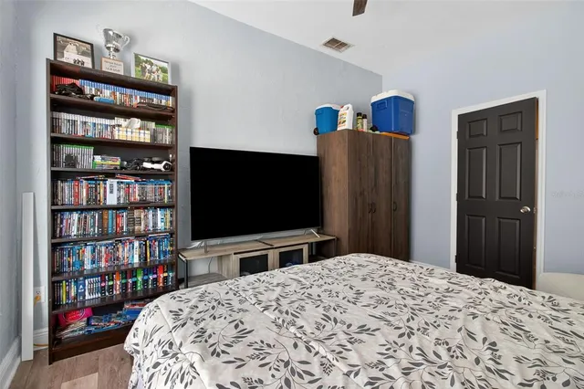 a bedroom with a bed and a flat screen tv