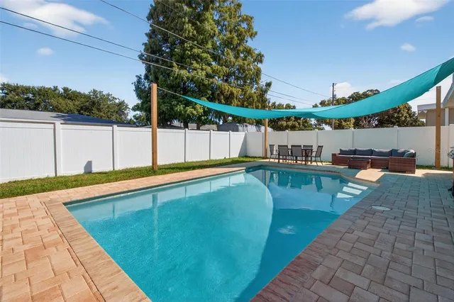 a view of a swimming pool with a patio