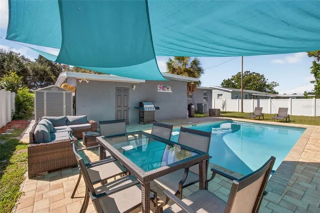 a view of a house with a backyard