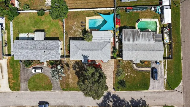 an aerial view of residential houses with outdoor space
