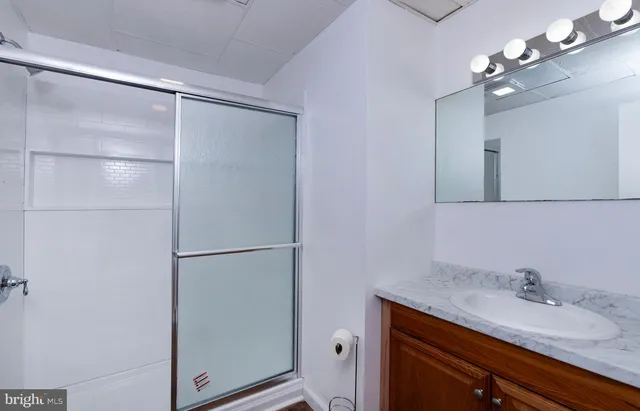 a bathroom with a granite countertop sink mirror and vanity