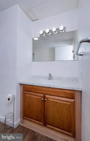 a bathroom with a sink a mirror and vanity