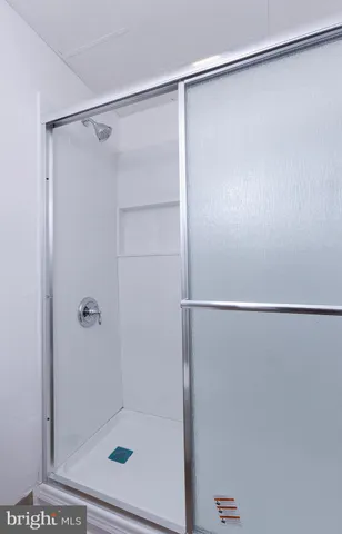 a bathroom with a glass shower door