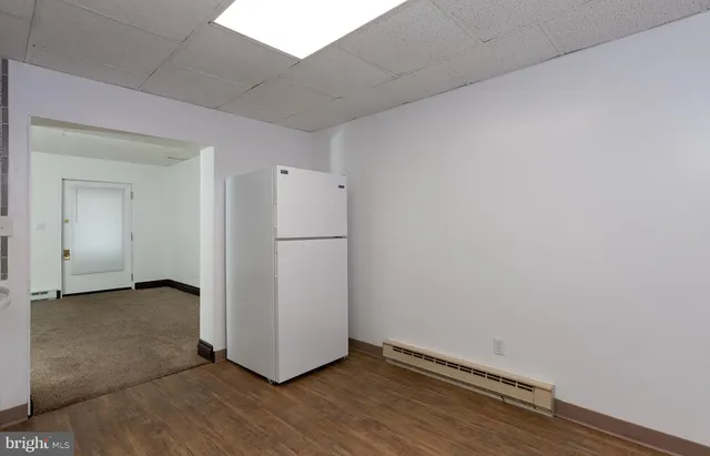 a view of a room with wooden floor
