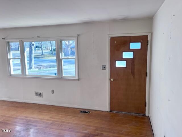 504 Winterlochen Road Raleigh, NC 27603 - Photo 11 of 39 a view of an empty room with wooden floor and a window