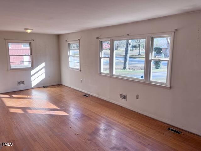 504 Winterlochen Road Raleigh, NC 27603 - Photo 14 of 39 a view of an empty room with wooden floor and a window