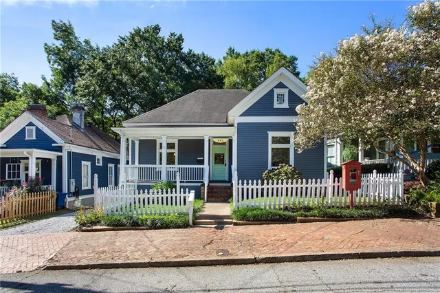 a front view of a house with a garden and deck