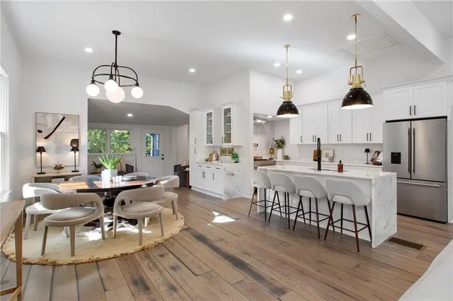 a large kitchen with a table and chairs