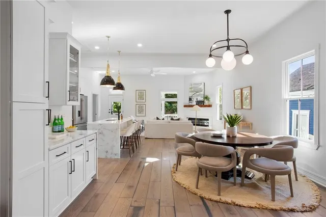 a large kitchen with a counter space a sink appliances and dining table