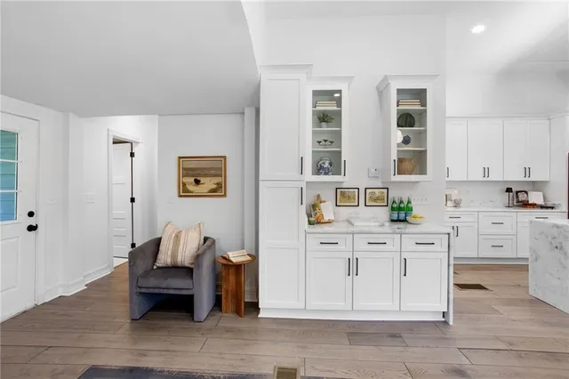 a kitchen with stainless steel appliances cabinets and wooden floor