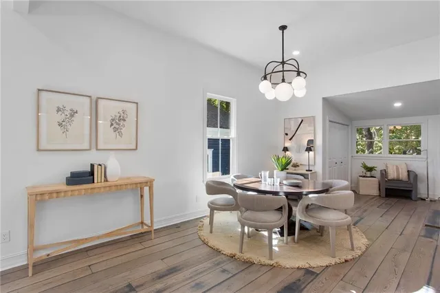 a view of a dining room with furniture window and wooden floor