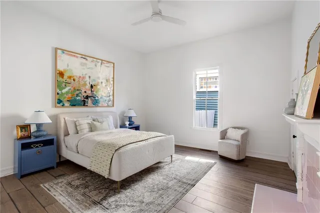 a bedroom with a bed and a painting on the wall