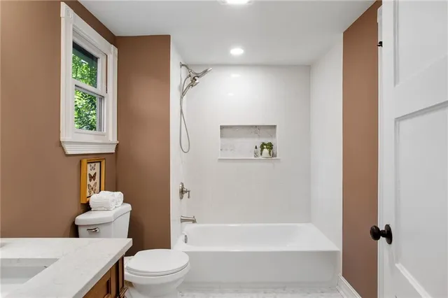 a bathroom with a toilet sink and bathtub