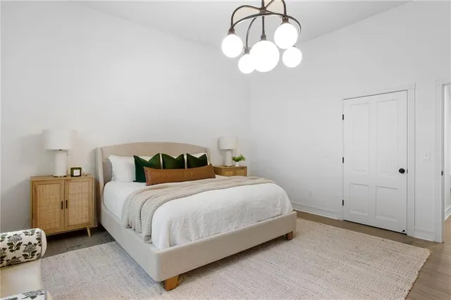 a bedroom with a bed and chandelier