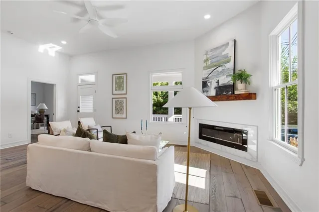 a living room with furniture a fireplace and a flat screen tv