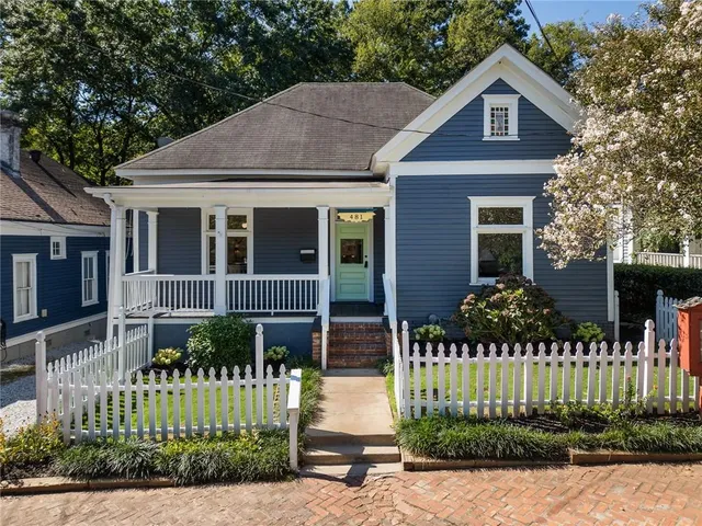a front view of a house with a garden