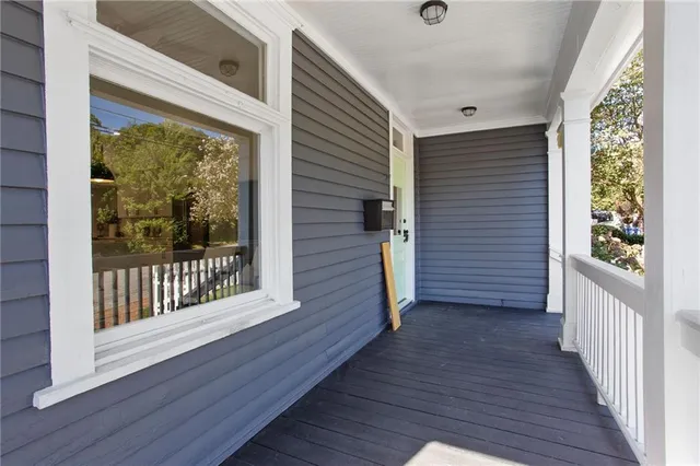 a view of front door deck and wooden floor