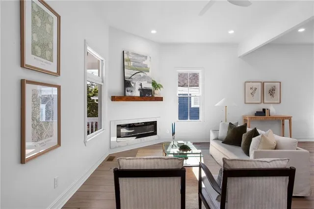 a living room with furniture and a wooden floor