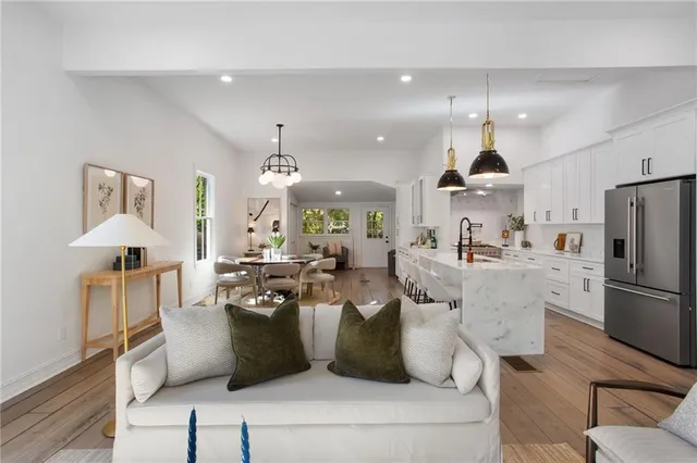 a living room with furniture kitchen and a chandelier