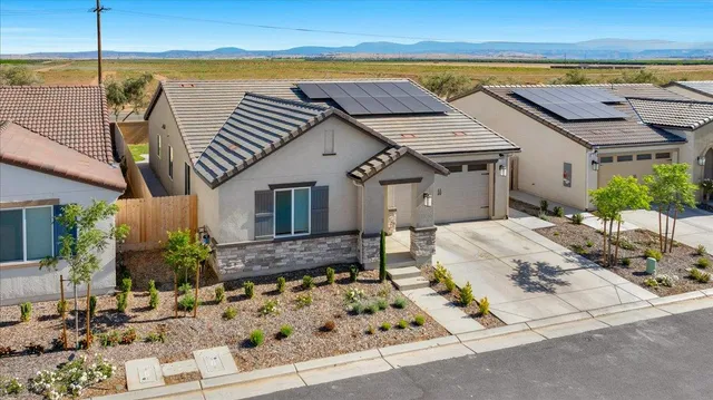 a view of a house with outdoor space and sitting area