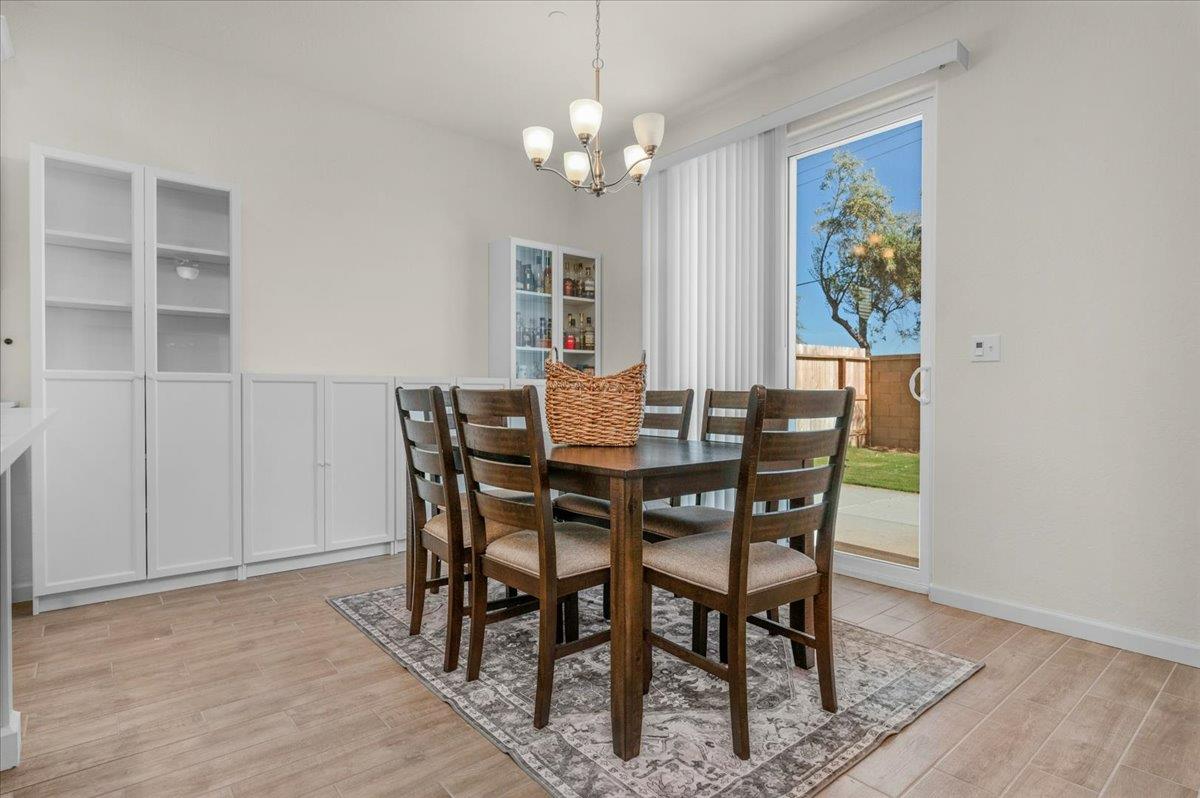 1183 Encore Way West Madera, CA 93636 - Photo 19 of 46 a view of a dining room with furniture and wooden floor