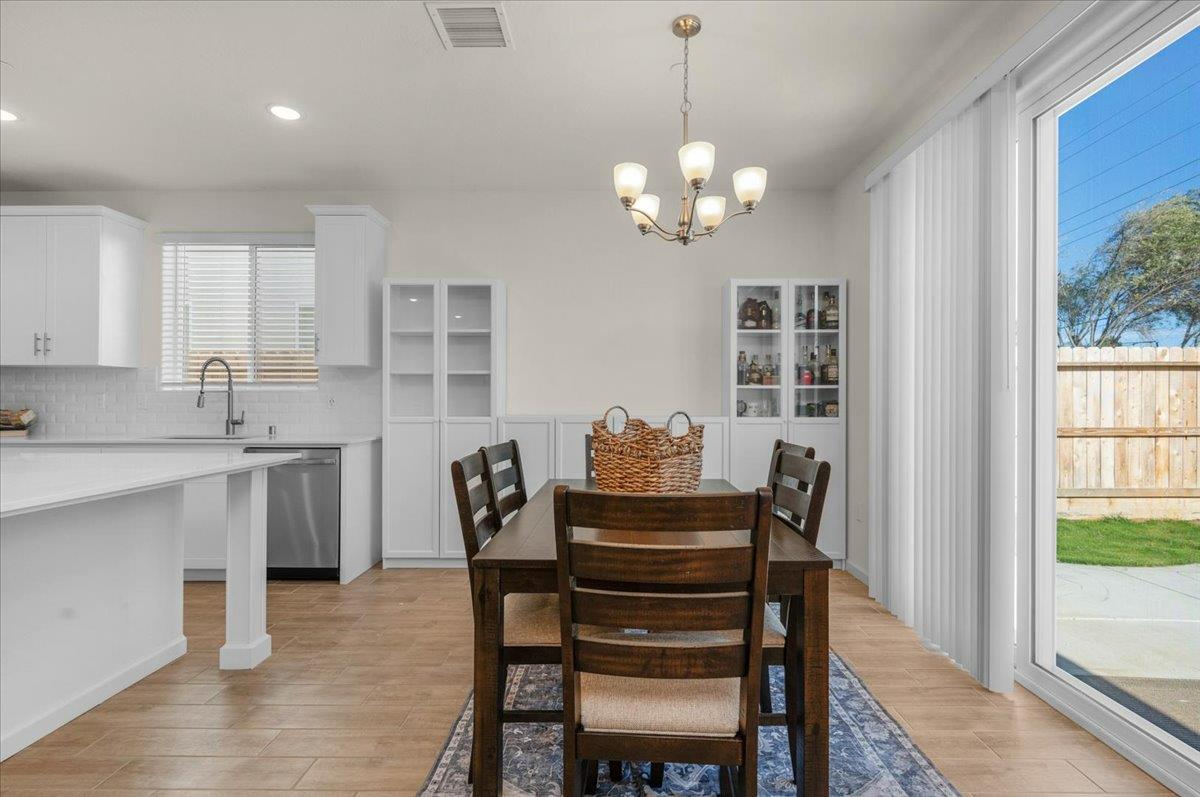 1183 Encore Way West Madera, CA 93636 - Photo 20 of 46 a view of a dining room with furniture window and wooden floor