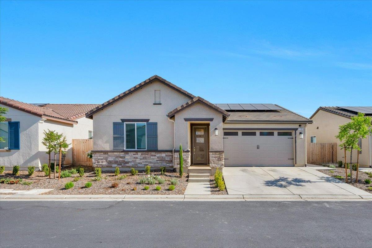 1183 Encore Way West Madera, CA 93636 - Photo 2 of 46 a front view of a house with a yard