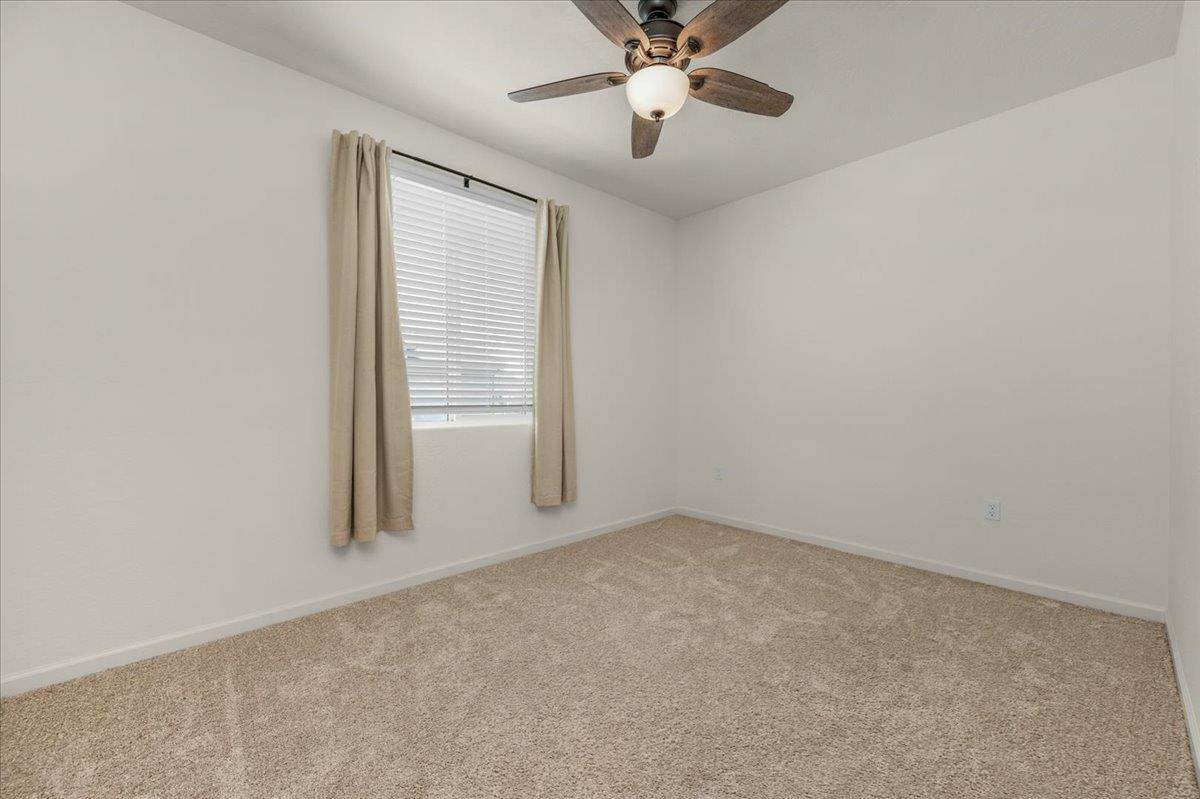 1183 Encore Way West Madera, CA 93636 - Photo 21 of 46 an empty room with a window and a fan