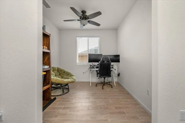 a view of a workspace with furniture and a window