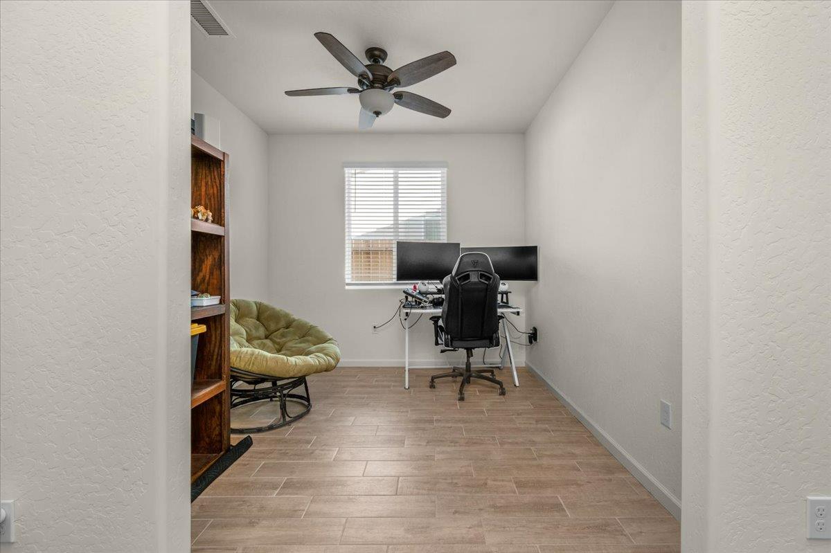 1183 Encore Way West Madera, CA 93636 - Photo 22 of 46 a view of a workspace with furniture and a window