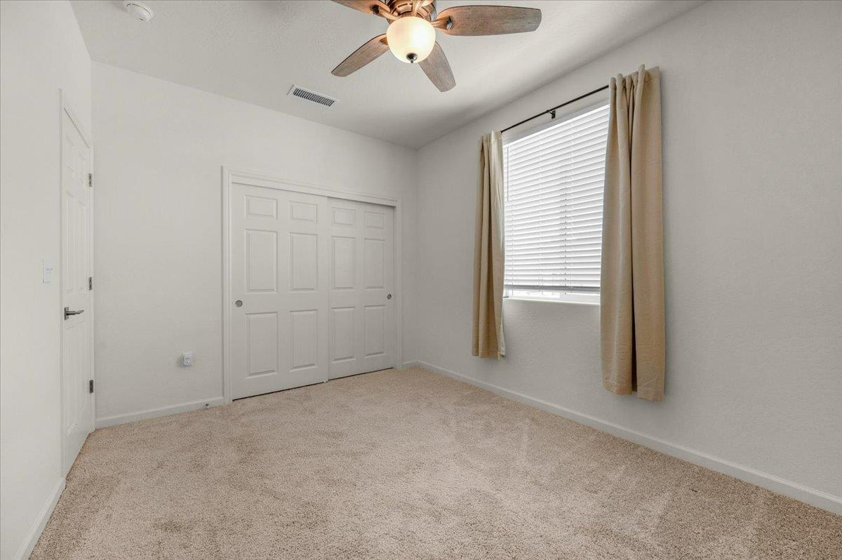 1183 Encore Way West Madera, CA 93636 - Photo 24 of 46 an empty room with chandelier fan and windows