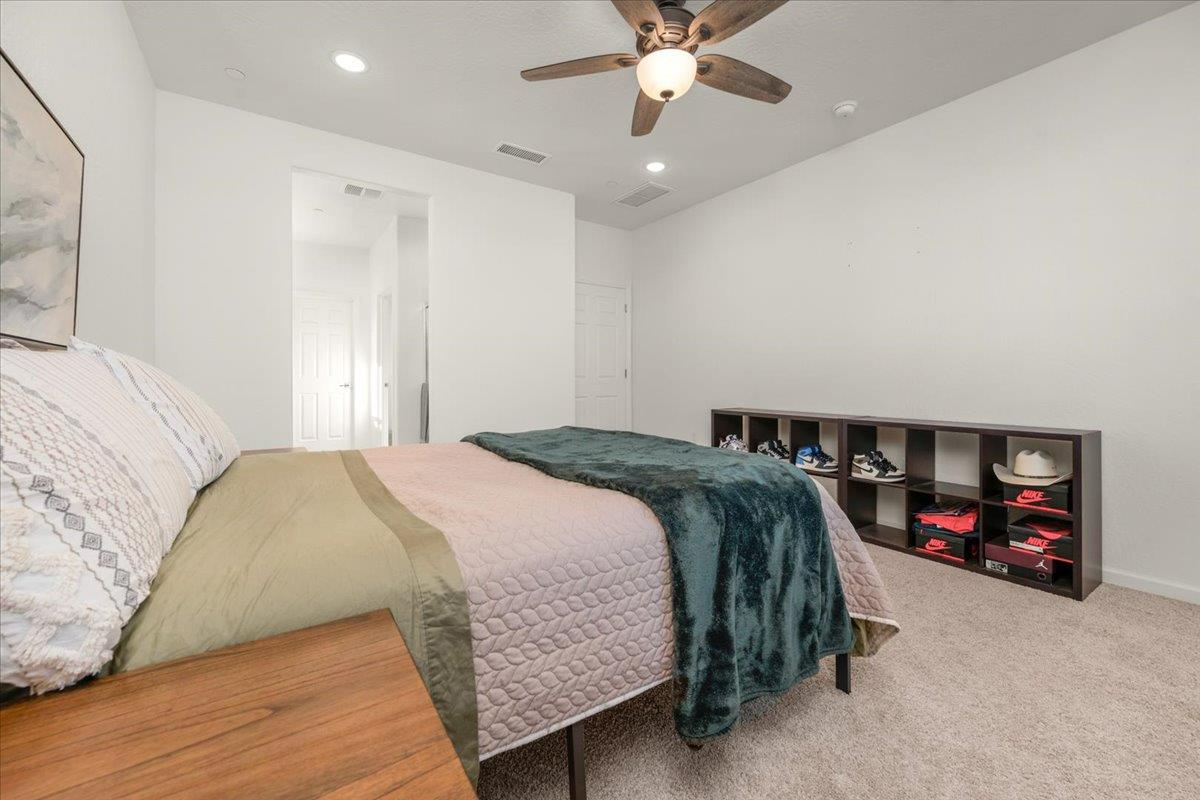 1183 Encore Way West Madera, CA 93636 - Photo 31 of 46 a bedroom with a bed and a chandelier