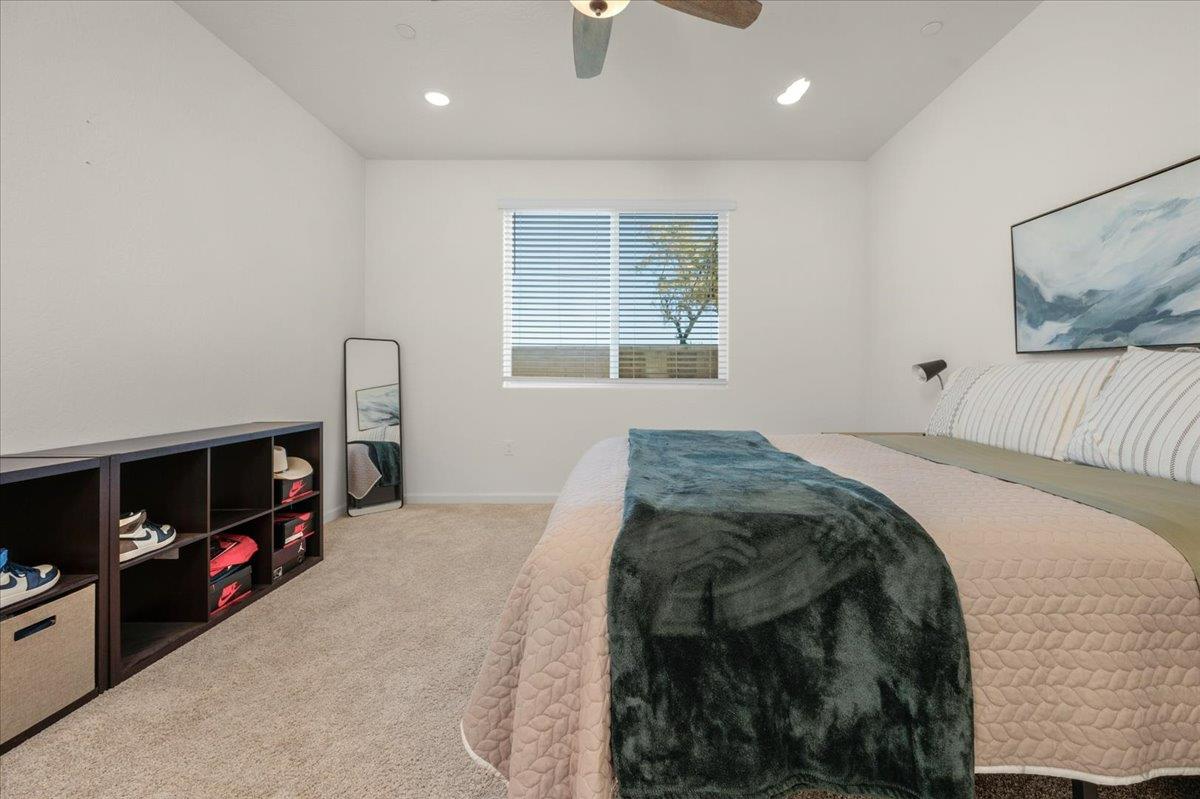 1183 Encore Way West Madera, CA 93636 - Photo 32 of 46 a bed sitting in a bedroom next to a window