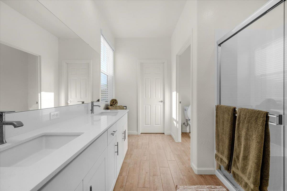 1183 Encore Way West Madera, CA 93636 - Photo 33 of 46 a bathroom with a double vanity sink and mirror