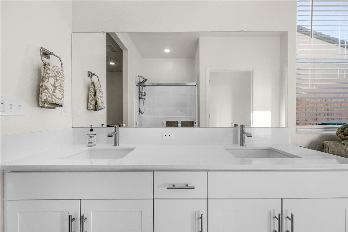 1183 Encore Way West Madera, CA 93636 - Photo 34 of 46 a bathroom with double vanity sinks and a mirror