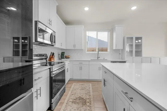 a kitchen with cabinets and window