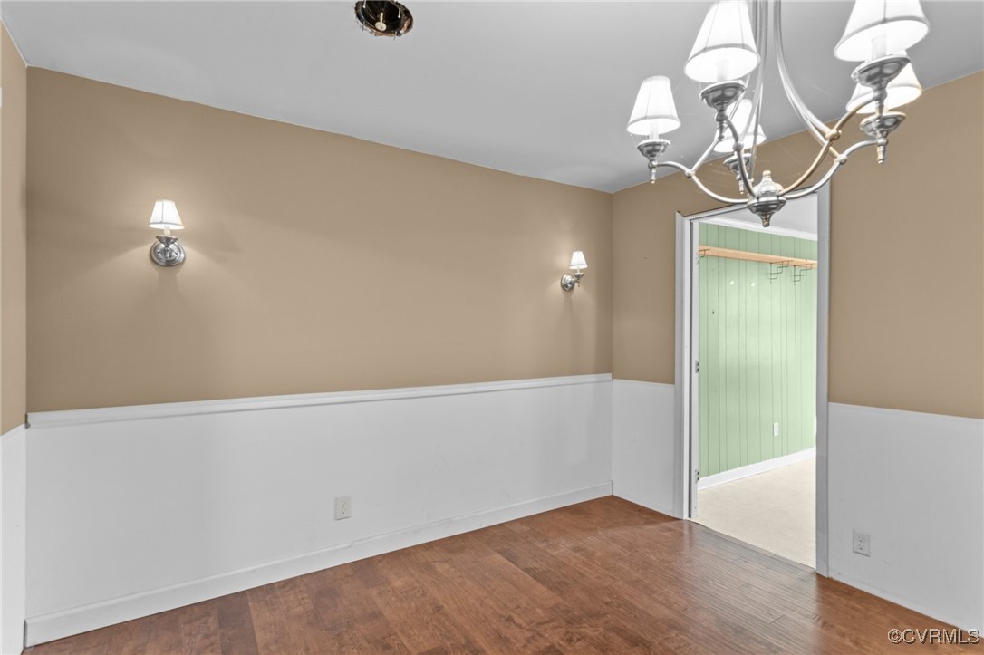 911 Maple Street Ashland, VA 23005 - Photo 17 of 35 a view of a room with wooden floor and chandelier