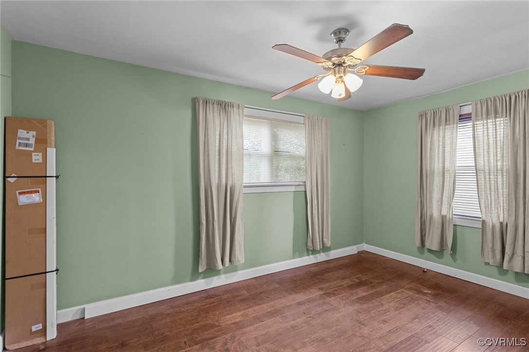 911 Maple Street Ashland, VA 23005 - Photo 25 of 35 an empty room with wooden floor fan and windows