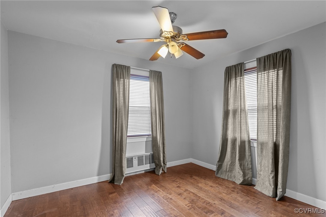 911 Maple Street Ashland, VA 23005 - Photo 30 of 35 an empty room with wooden floor fan and windows