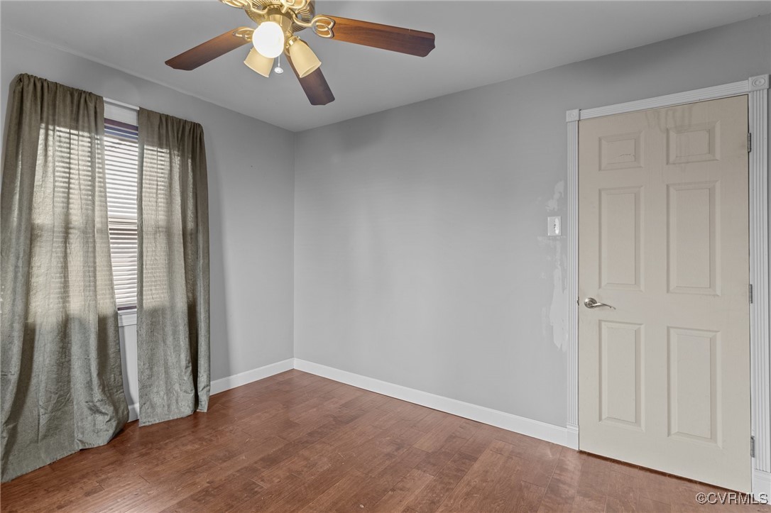911 Maple Street Ashland, VA 23005 - Photo 31 of 35 an empty room with wooden floor fan and windows