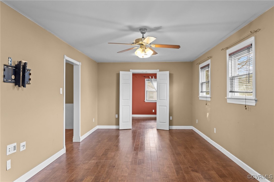 911 Maple Street Ashland, VA 23005 - Photo 9 of 35 a view of an empty room with window and wooden floor