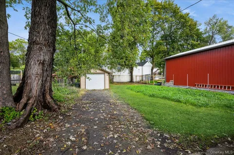 a view of a house with a yard and tree s