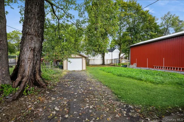 a view of a house with a yard and tree s