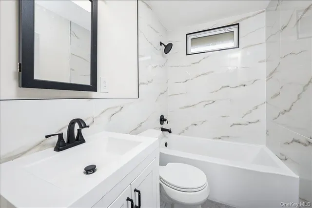 a bathroom with a sink a toilet and a bathtub