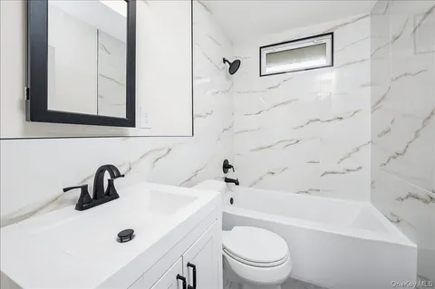 a bathroom with a sink a toilet and a bathtub